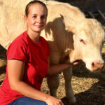 lady posing in front of her livestock